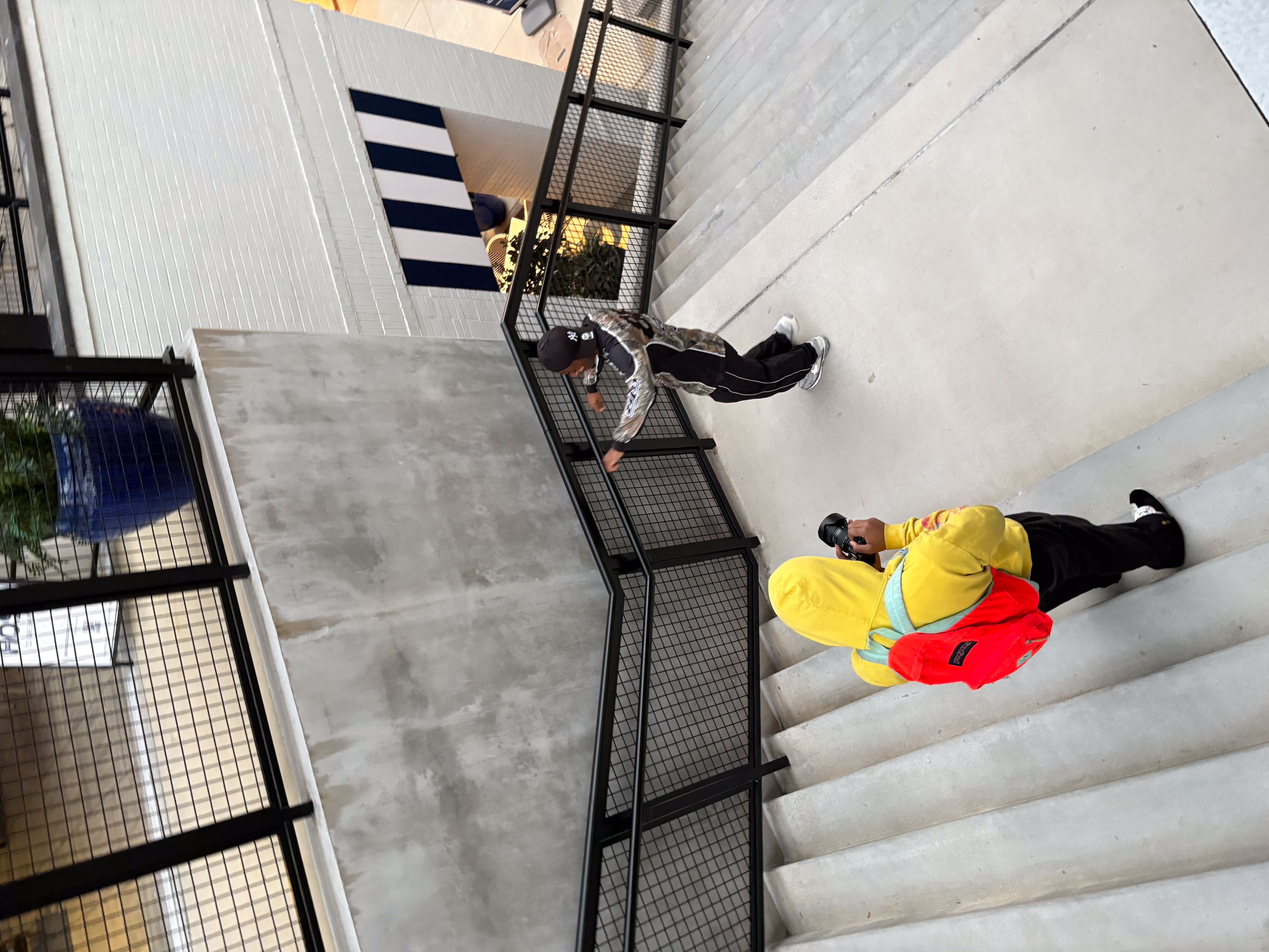 Benji in yellow hoodie on urban staircase