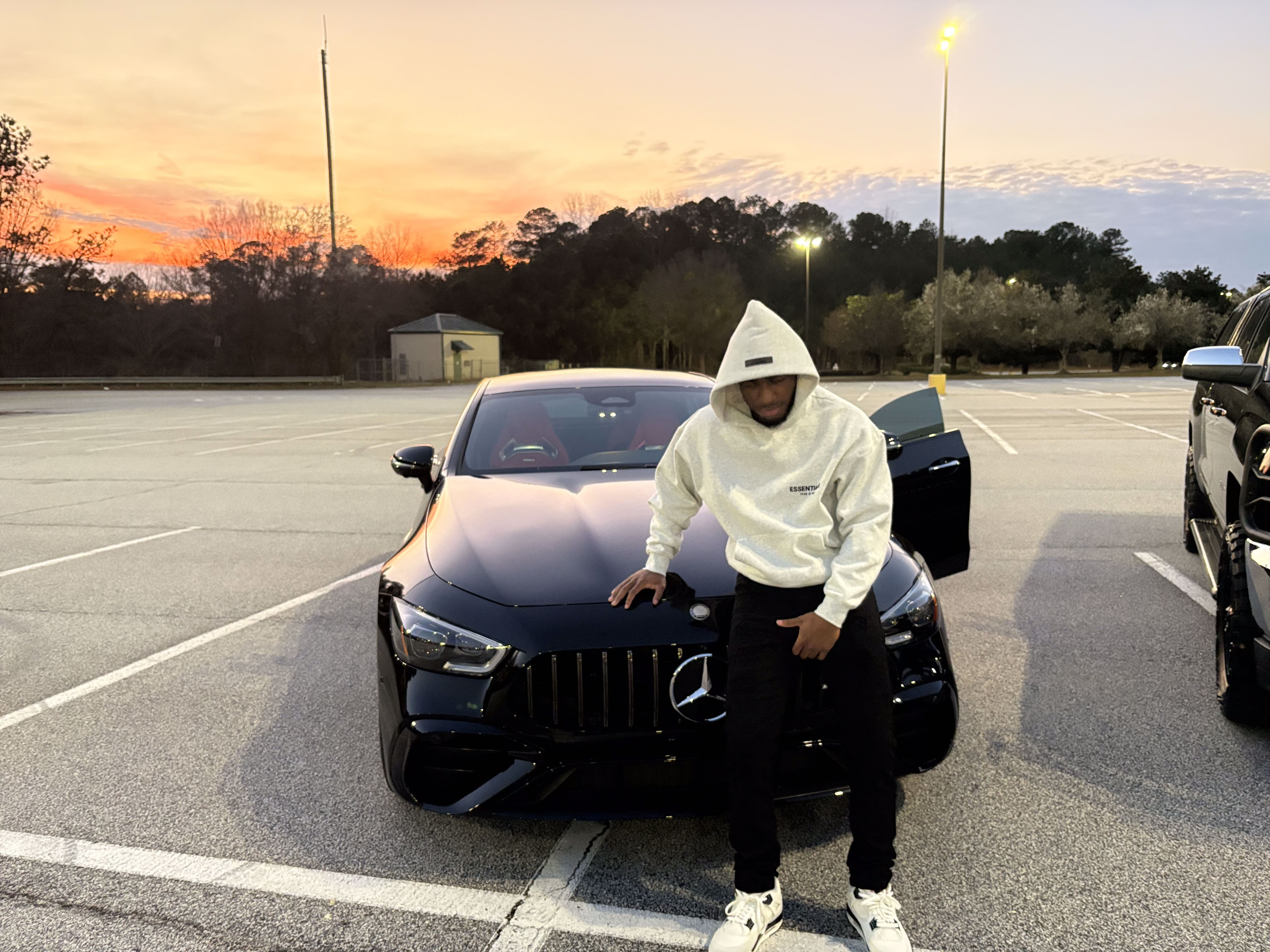 Benji at sunset with black Mercedes