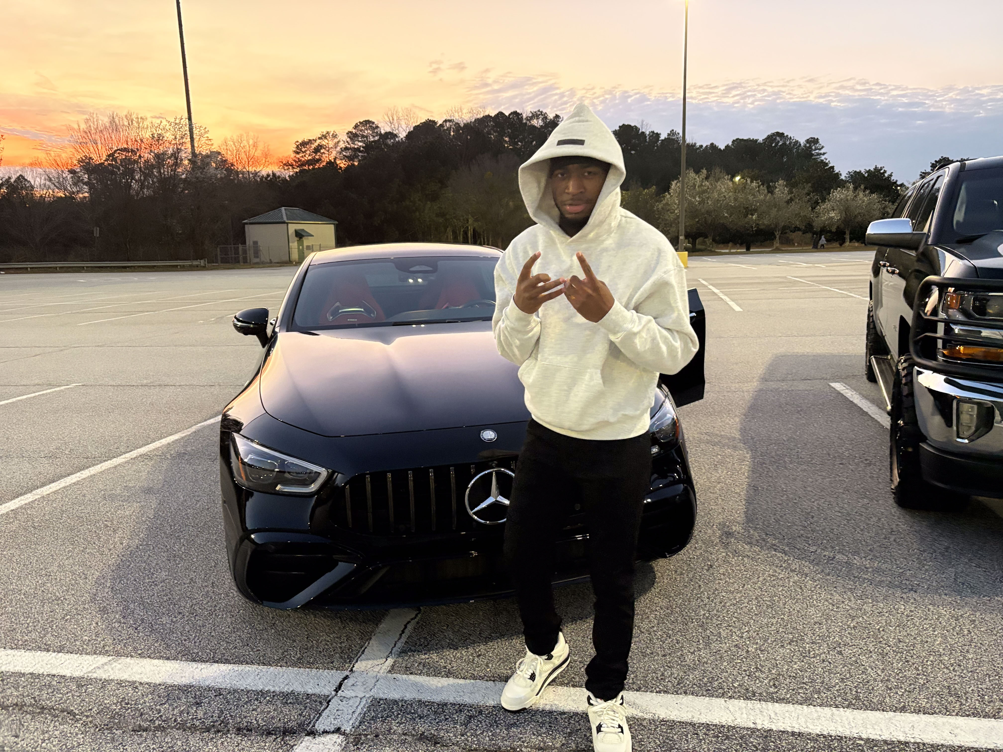 Benji in front of Mercedes at golden hour
